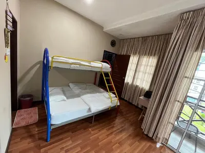 a bedroom with a bunk bed with a ladder at EagleNest at Iris House Resort in Tanah Rata