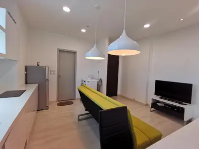 a living room with a yellow couch and a television at Strait Garden Studio X Ace Pro @ George Town in George Town
