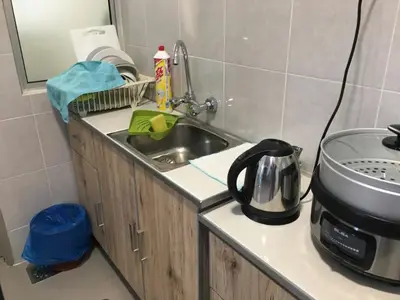 a kitchen counter with a sink and a microwave at Cahaya Gardens 2 rooms at Golden Hills depan pasar malam in Brinchang
