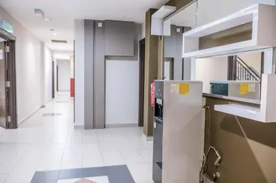 a kitchen with a refrigerator and a hallway at K West Hotel in Sitiawan