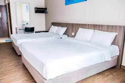 a large white bed in a hotel room at K West Hotel in Sitiawan