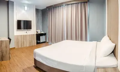 a hotel room with a bed and a television at K West Hotel in Sitiawan