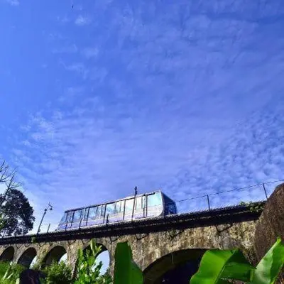 a train on a bridge with a blue sky at Fastbook Bendera Home 8 & 10pax in Ayer Itam