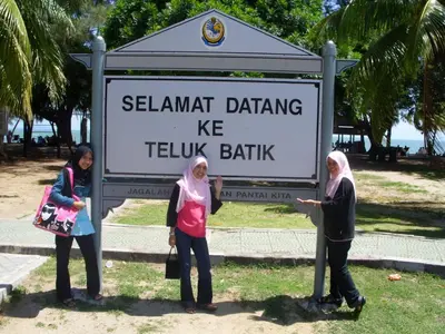 three women standing in front of a sign at Syaqisya Homestay in Seri Manjung