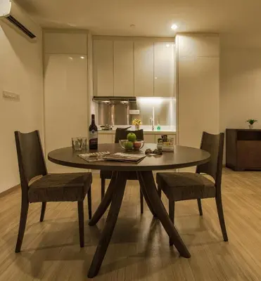 a dining room table and chairs in a kitchen at Luxfort 118 Service Suites in George Town