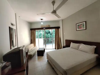 a bedroom with a bed and a tv and a window at Jana View Condotel MN in Kamunting