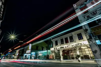 a building on a city street at night at Earnest Hotel Georgetown in George Town