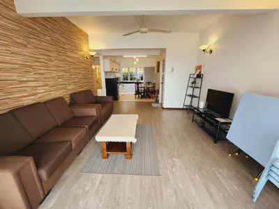 a living room with a couch and a table at Little England B5-2 Fraser Panorama in Bukit Fraser