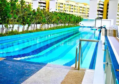a large swimming pool with blue water in a building at The Landmark by Katana 4BR Luxury Seaview Homestay Gurney\u65e0\u654c\u6d77\u666f\u56db\u623f\u5957\u623f in Tanjong Tokong