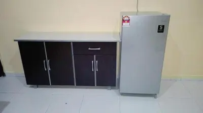 a kitchen with a counter and a refrigerator at Nurul Homestay in Kepala Batas