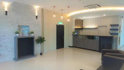 a lobby with a couch and a counter in a building at Legacy Hotel Ipoh in Ipoh
