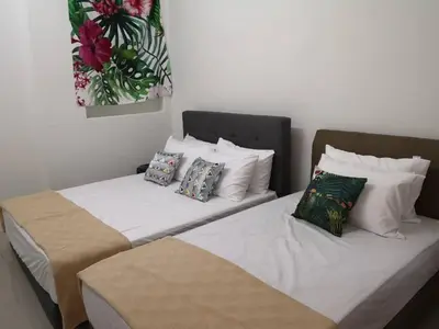 two beds sitting next to each other in a room at 3133 Heritage Home in George Town