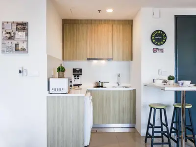 a kitchen with a counter and some stools in it at Tropicana 218 Macalister Studio with Seaview in George Town