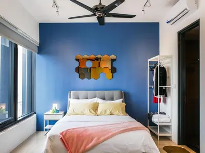 a blue bedroom with a bed and a ceiling fan at Tropicana 218 Macalister Studio with Seaview in George Town