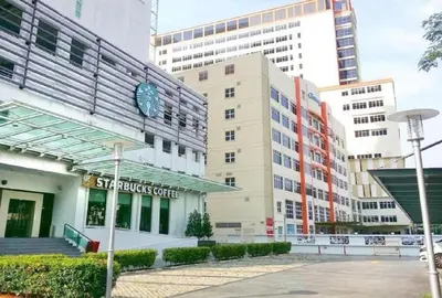 a building with a clock on the side of it at Mansion One, Private Room in George Town