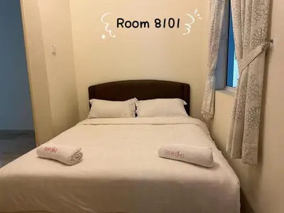 a bedroom with a bed with two towels on it at Dear Dino House in Tanah Rata