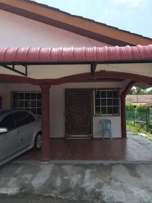 a car parked in front of a house with a blue chair at AMIMAS HOMESTAY in Kampong Telok