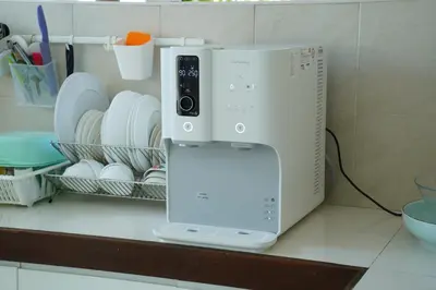 a microwave sitting on top of a counter with dishes at Smell rose beach garden in Batu Ferringhi
