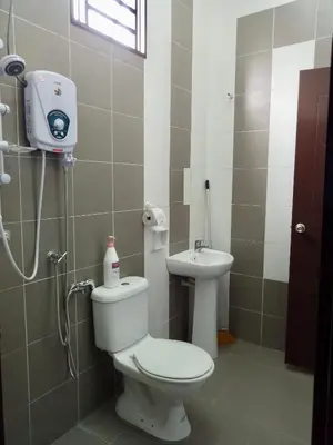 a bathroom with a toilet and a sink at Kampar Sakura 3 Landed in Kampar