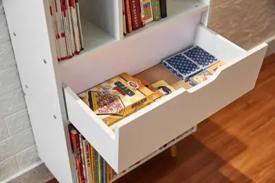 a drawer in a book shelf filled with books at Ipoh Garden Homestay in Ipoh