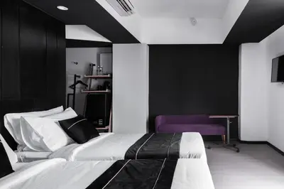 a bedroom with a bed and a purple chair at Loop On Leith George Town Penang Hotel in George Town
