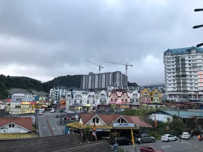 a city with buildings and cars on a street at Super Budget 3 Rooms Apartment @ Brinchang Town in Brinchang
