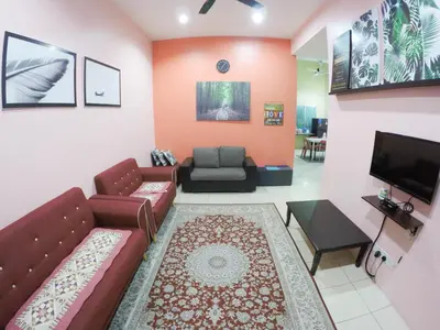 a living room with a couch and a tv at D HOMESTAY SERI ISKANDAR in Seri Iskandar
