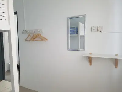 a white refrigerator with a mirror on a wall at PINKY VILLA in Ipoh