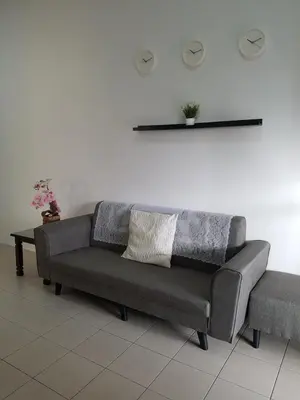 a couch in a room with a white wall at PINKY VILLA in Ipoh