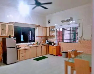 a kitchen with a refrigerator and a ceiling fan at Taiping Vacation Home in Taiping