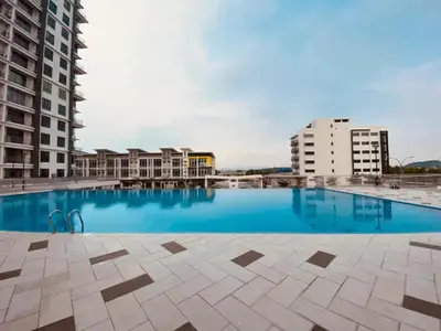 a large swimming pool with buildings in the background at Lovely Home Casa Kayangan A2207 in Ipoh