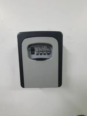 a black and white remote control attached to a wall at 80'S PARADISE in Tanah Rata