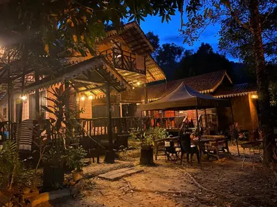 a house with a tent and a table and chairs at Rustic Chalet - Dahlia n Mawar at Sedim Vista in Kampong Ulu Sedim