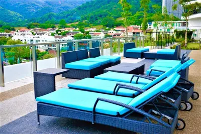 a group of blue chairs sitting on top of a balcony at Seaview Landmark Studio Homestay at Gurney \u65e0\u654c\u6d77\u666f\u5957\u623f in Tanjong Tokong