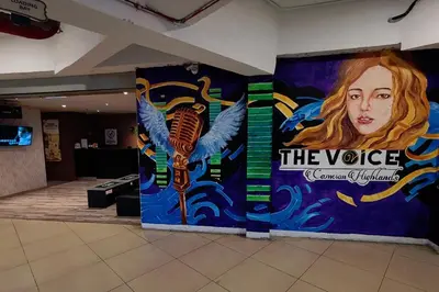 a large painting of a woman with wings on a wall at Aranda Nova Suite in Cameron Highlands