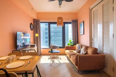 a living room with a couch and a table at Georgetown Tropicana 218 by Airlevate Suites in George Town