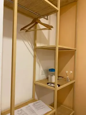 a book shelf in a kitchen with a paper on the floor at TT Dorf Hotel Taiping in Taiping