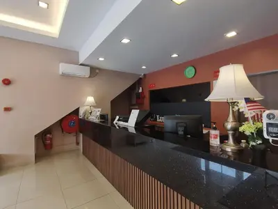 a lobby of a hotel with a reception counter at Lumut Hotel in Lumut
