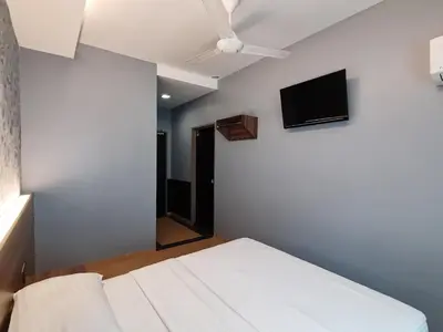 a bedroom with a bed and a ceiling fan at Lumut Hotel in Lumut