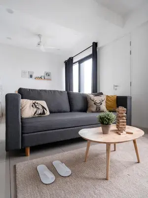 a living room with a couch and a table at Muji Studio 1 - Seaview at 218 Tropicana Near Komtar Food Heaven with Netflix & TV Box in George Town