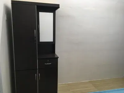 a black cabinet with a mirror on top of it at Homey Hostel, Ipoh Town in Ipoh