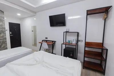 a bedroom with a bed and a tv on the wall at Lee Luxury Home USM Penang in Gelugor