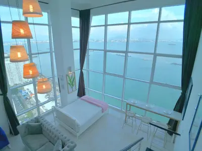 a living room with a large window view of the water at Maritime Suites by Comfy in George Town
