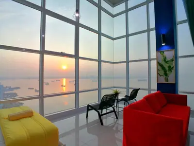 a living room with a red couch and chairs at Maritime Suites by Comfy in George Town