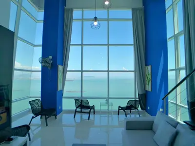 a large room with chairs and a large window at Maritime Suites by Comfy in George Town