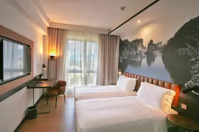 a hotel room with two beds and a television at Travelodge Ipoh in Ipoh