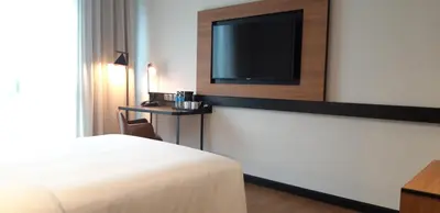 a hotel room with a bed and a flat screen tv at Travelodge Ipoh in Ipoh