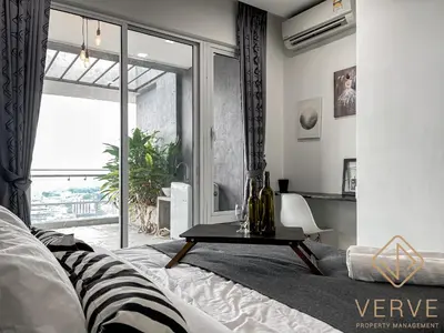 a bedroom with a bed and a table and a window at Ipoh Octagon Premium Suites by Verve in Ipoh