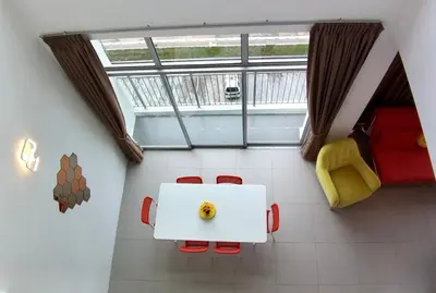 a room with a table and chairs and a window at The PENT Duplex Cameron in Tanah Rata