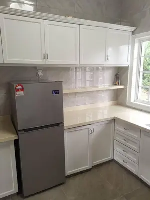 a kitchen with white cabinets and a refrigerator at Hills Sanctuary Retreat, B7-3A-2 with WI-FI in Bukit Fraser